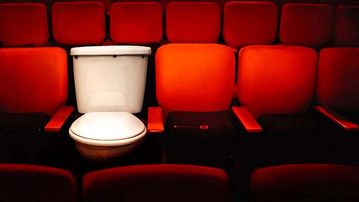 A toilet among a row of theatre seats